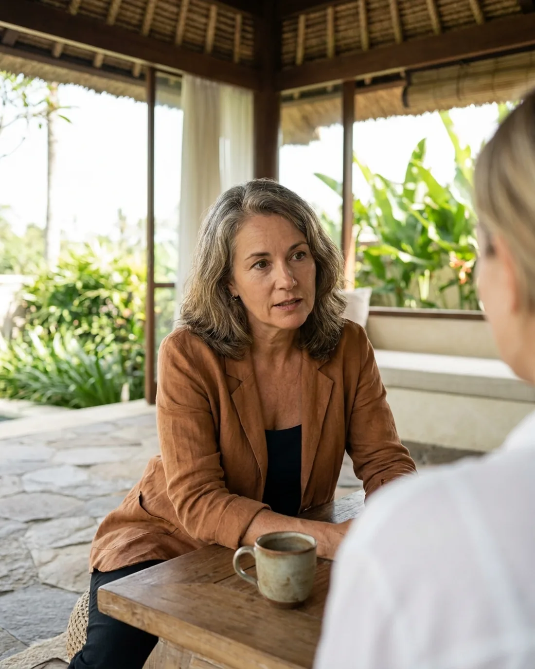 A senior CHRO reviewing the work in a calm Bali boardroom
